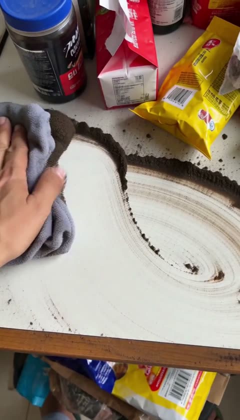 AI-generated hand wiping a dusty white surface with a cloth