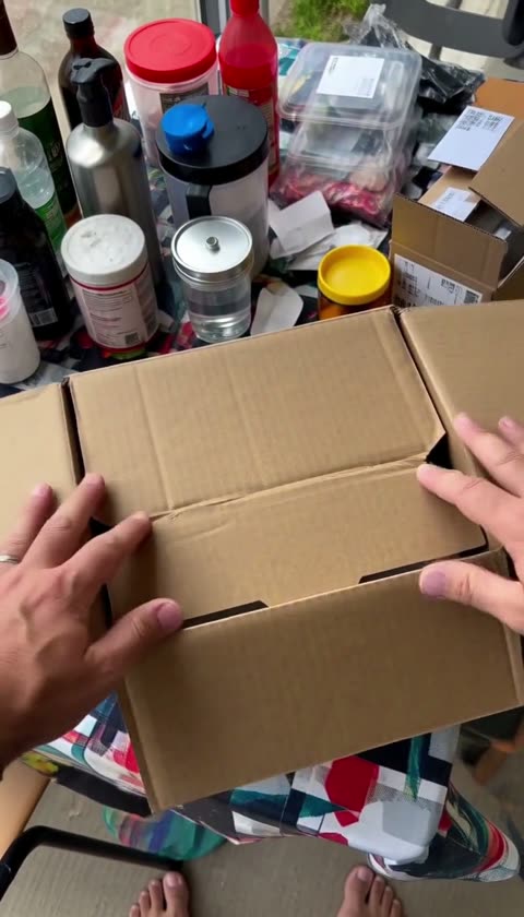 AI-generated hands opening a cardboard package on a table