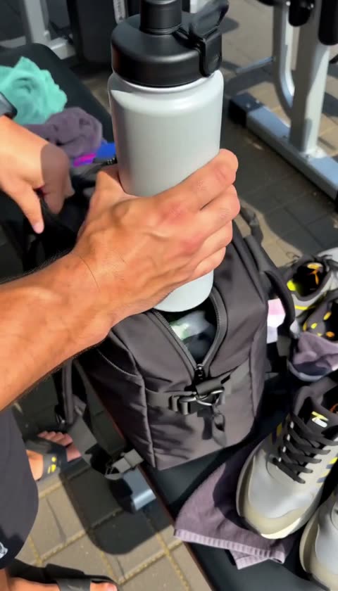 AI-generated hand holding a shaker bottle above a gym bag